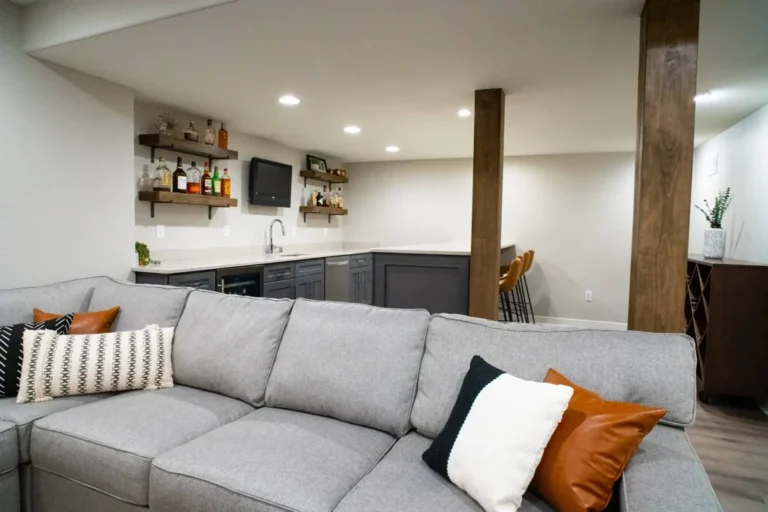 Finished basement lounge with sectional sofa and wet bar