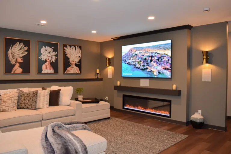 Basement media room with sectional sofa, wall-mounted TV, and fireplace